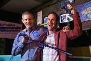 Democrats Del. Schuyler VanValkenburg, (right) and Del. Rodney Willett celebrate on stage at an election party in Richmond, Virginia.