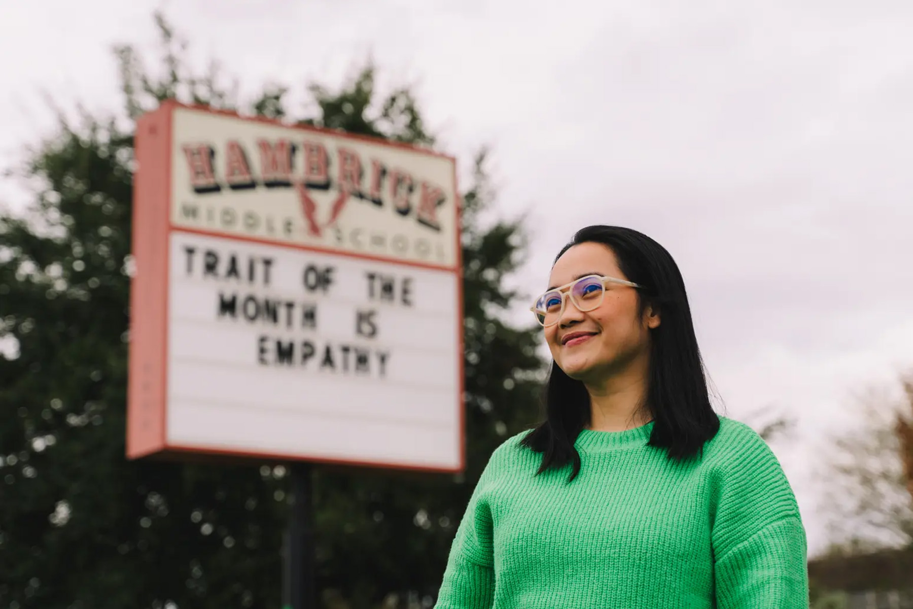 Ilona Cabudsan poses in front of a sign for Hambrick Middle School.