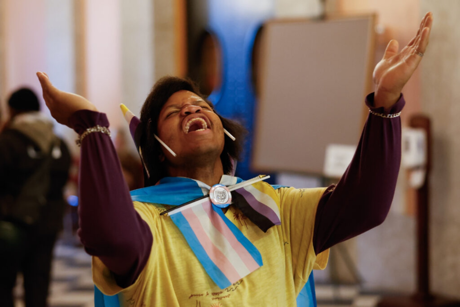 A person throws their head back as they chant.