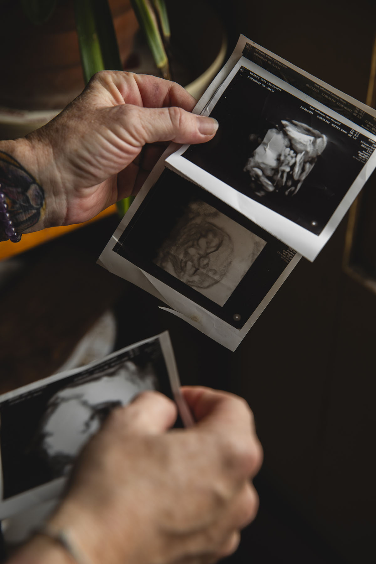 Sara Toups holds ultrasounds of her son.