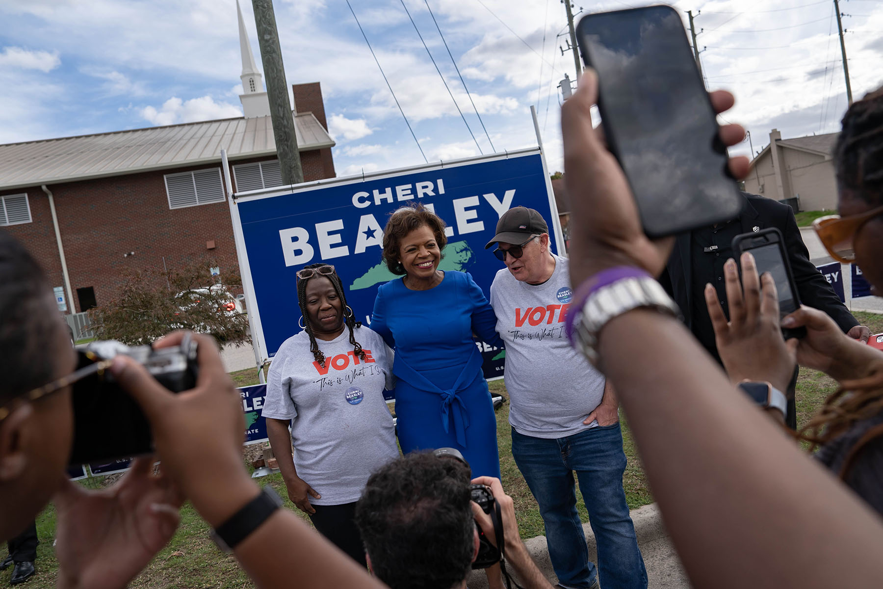 People take photos with Senate candidate Cheri Beasley at the Cumberland County Cookout and Canvass Launch event.