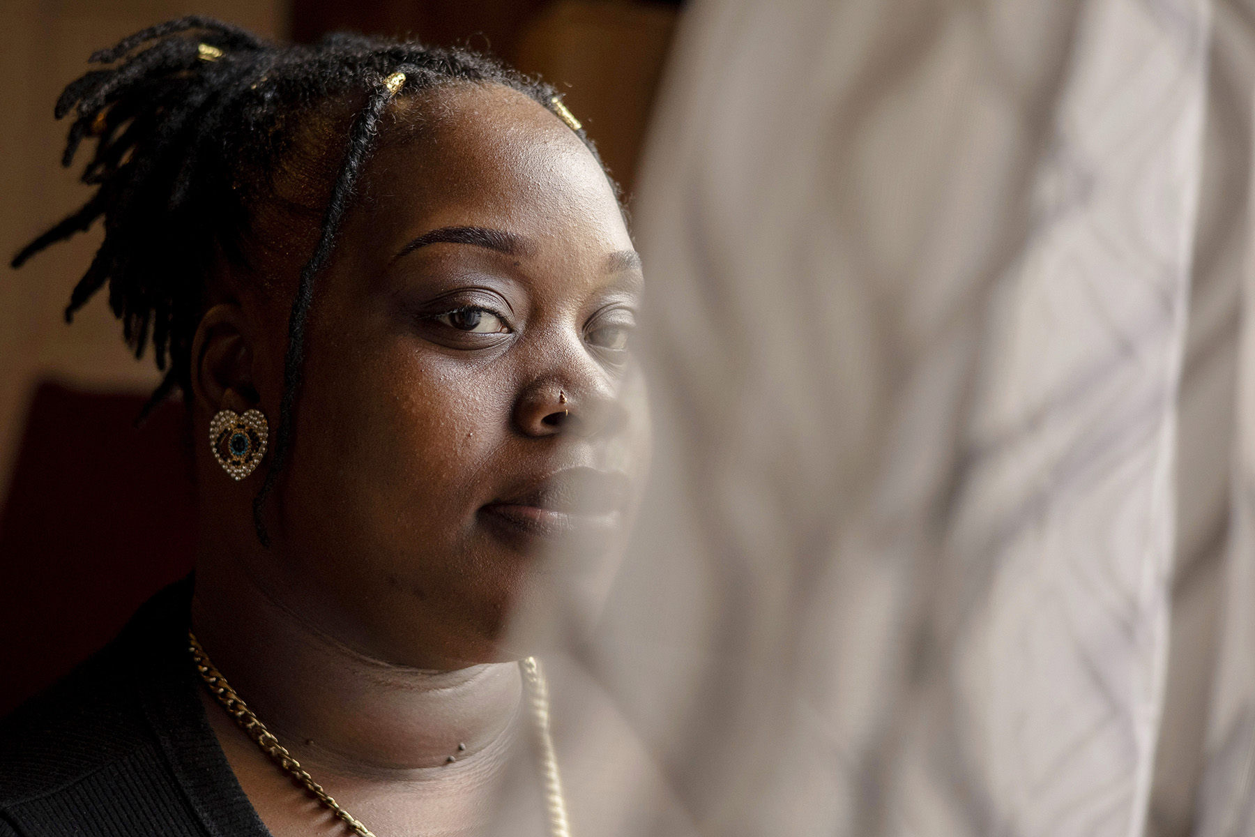 Davis poses for a portrait near a window at her home.