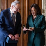 Senate Majority Leader Chuck Schumer presents Vice President Kamala Harris with a 