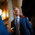 Sen. Tommy Tuberville speaks to reporters on his way to a closed-door lunch meeting with Senate Republicans.