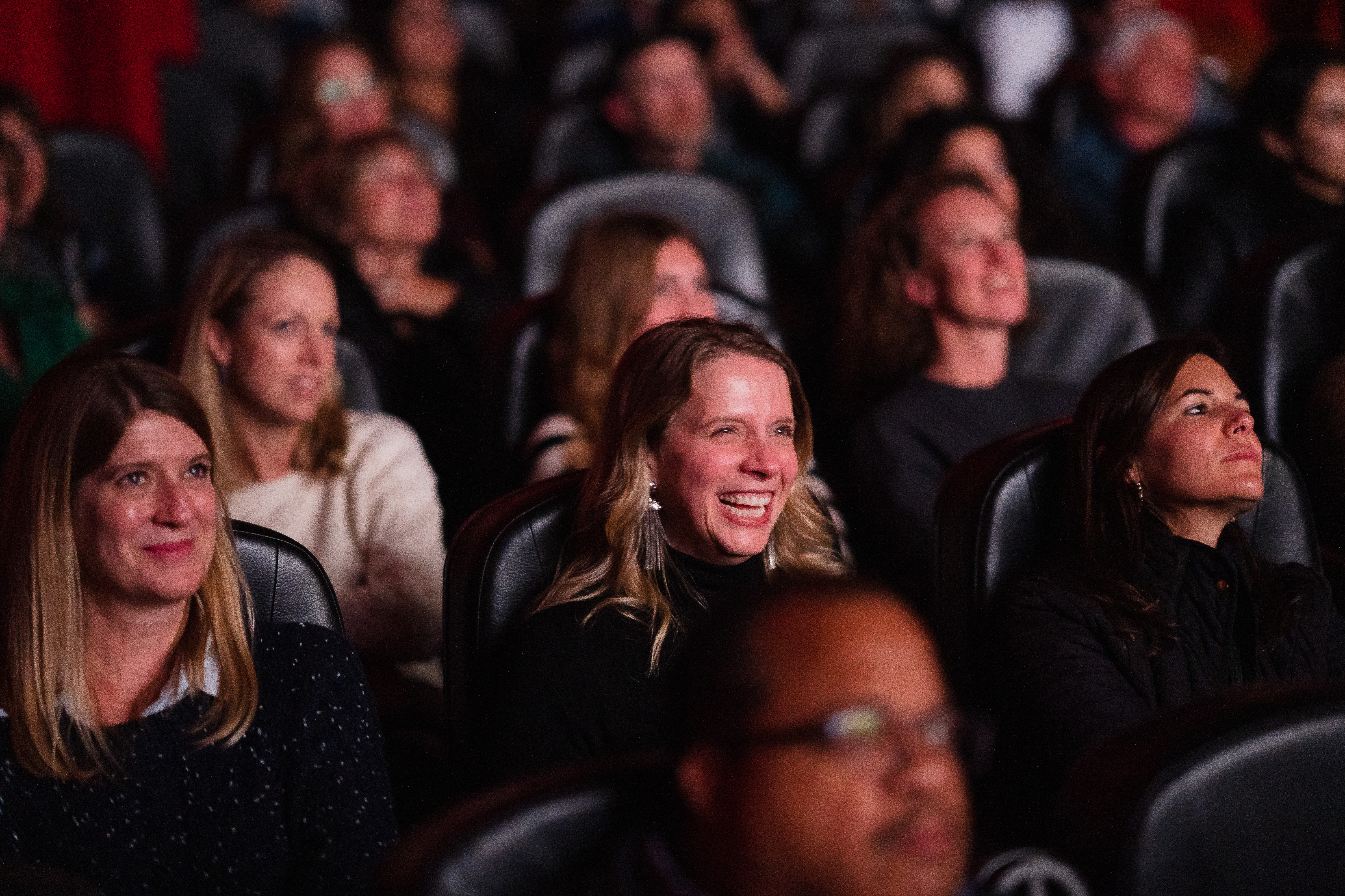 Audience members reacts during the Austin premiere of "Breaking the News" at the Austin Film Society.