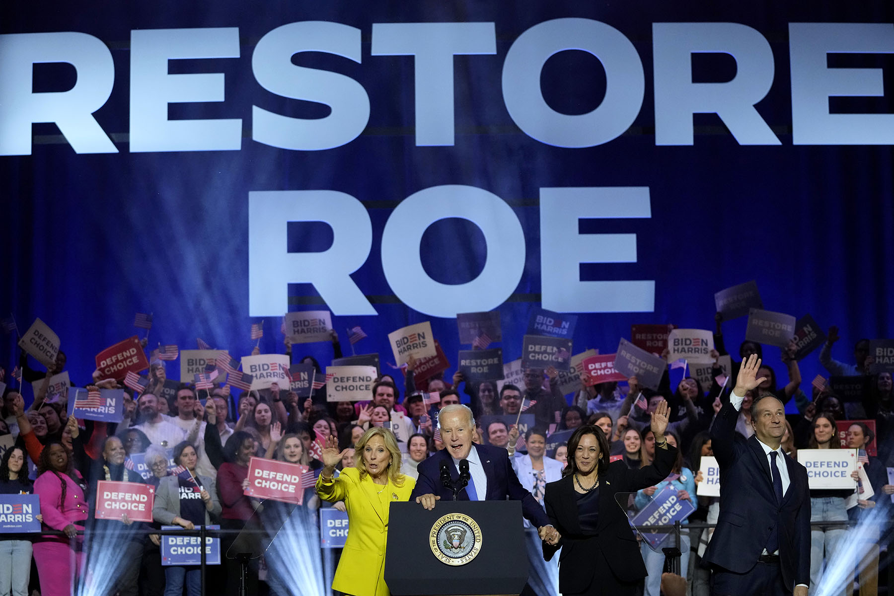 President Joe Biden is joined on stage by first lady Jill Biden, Vice President Kamala Harris and second gentleman Doug Emhoff at an event on the campus of George Mason University.