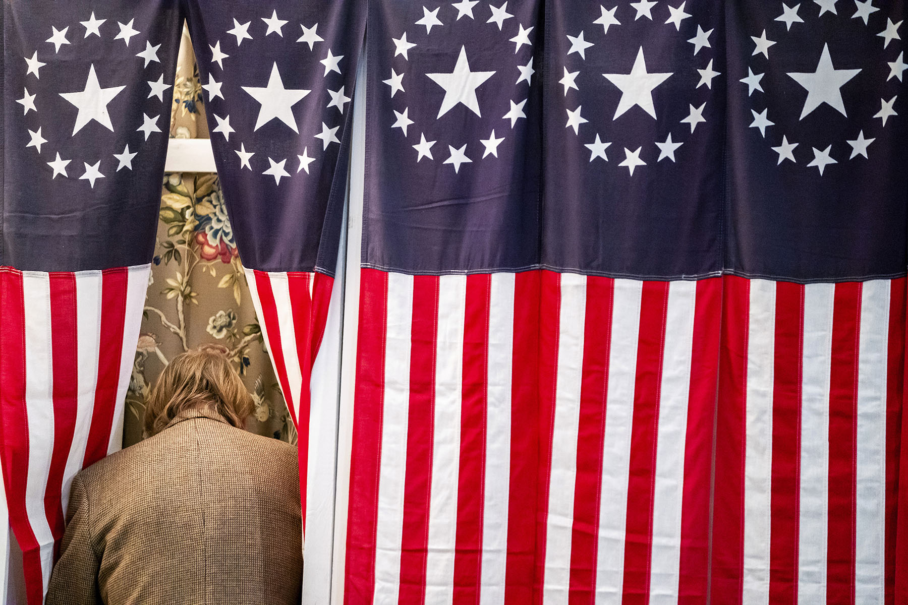 A voter enters a booth during the New Hampshire state's primary in Dixville Notch, New Hampshire.