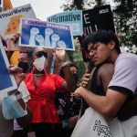 Students consoling one another outside the Supreme Court in Washington, D.C.