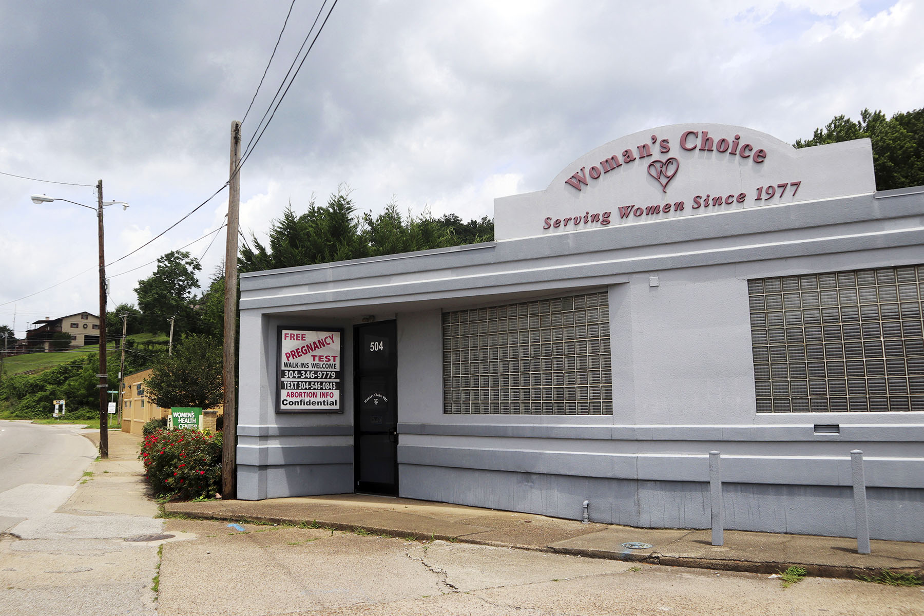 A sign advertises free pregnancy tests and abortion information outside the Woman's Choice Pregnancy Resource Center in Charleston, West Virginia.