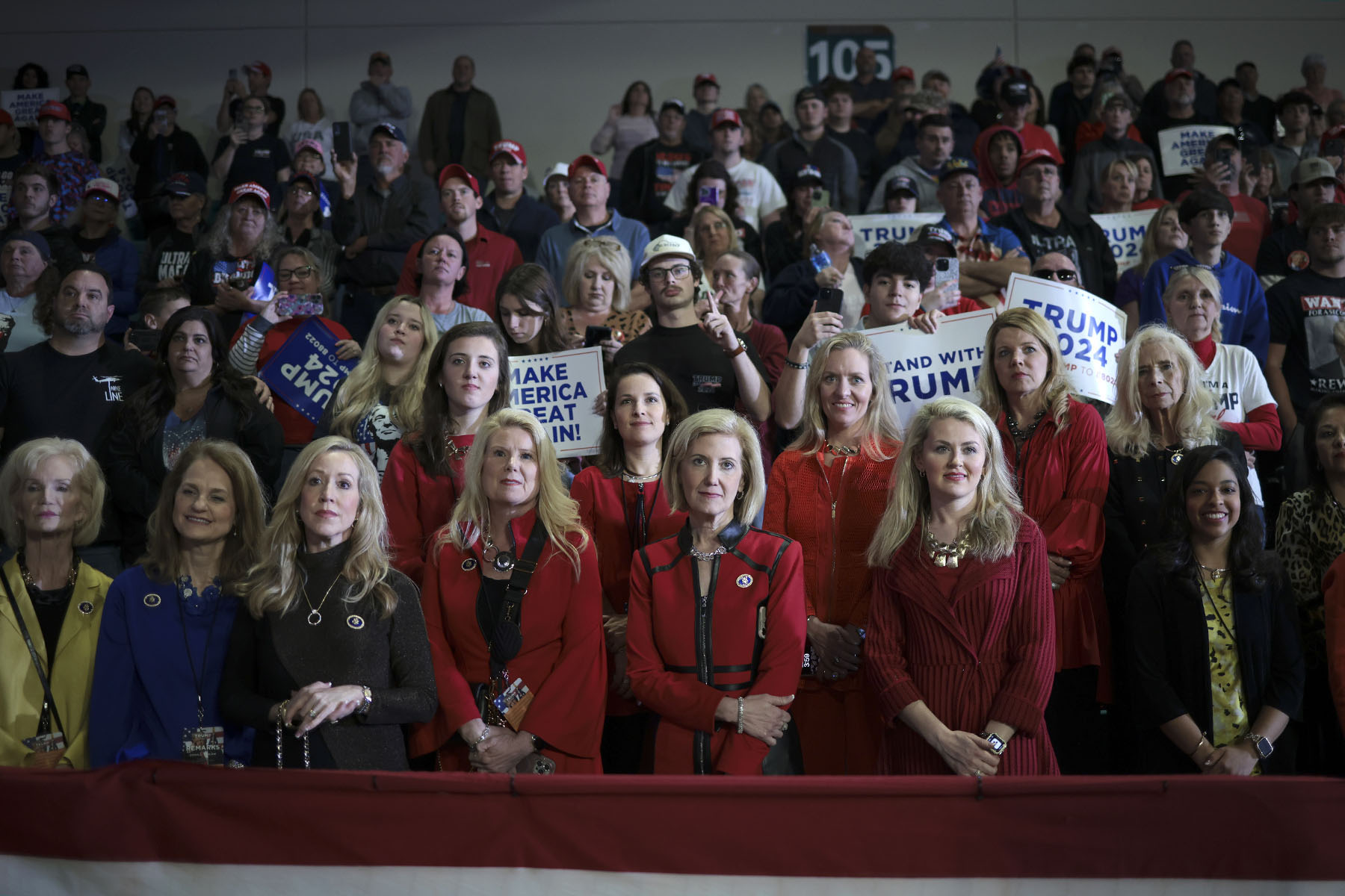 Supporters of former President Donald Trump listen while he speaks during a Get Out The Vote rally.