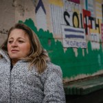 Emily Voorde sits for a portrait near a mural of South Bend, Indiana.