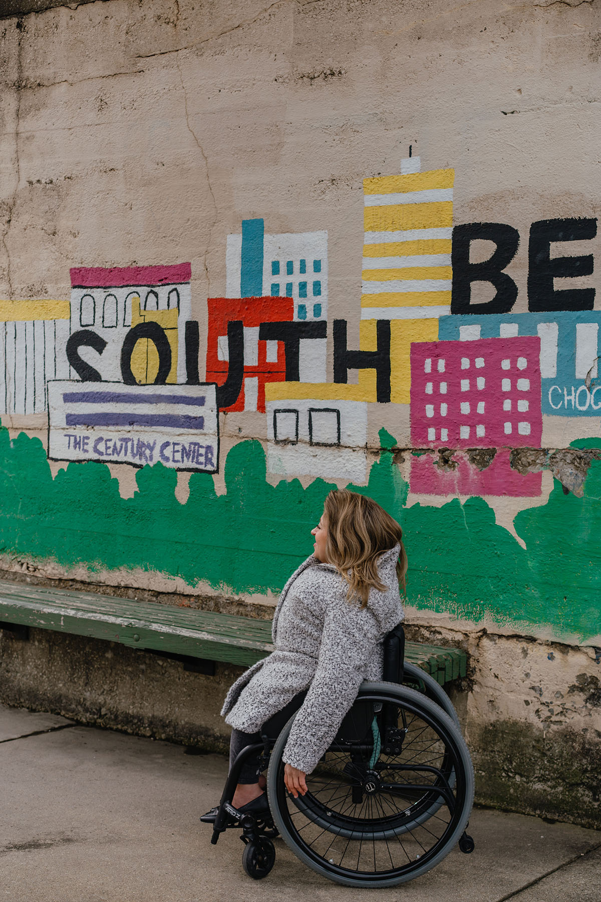 Emily Voorde poses for a portrait in front of a mural in South Bend, Indiana.