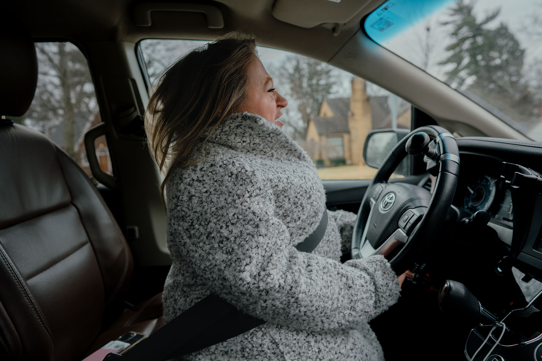 Emily Voorde drives her car that has been adapted with hand controls.