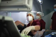 Doctors around a woman during a fertility treatment in a clinic.