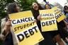 Student loan borrowers gather near The White House with signs.