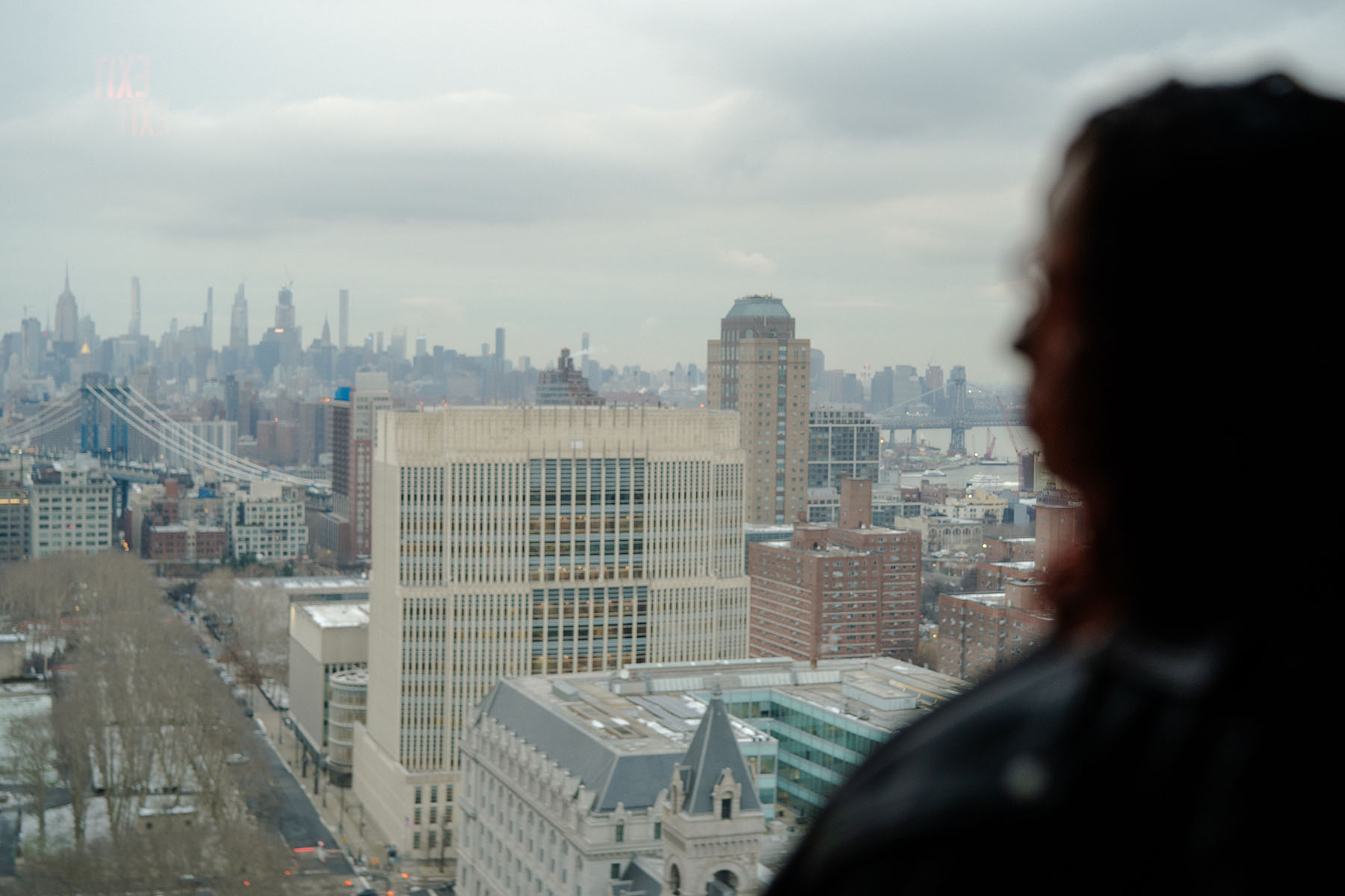 Thalia Gonzalez looks out a window to the City.