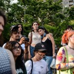 Two people are seen hugging as others listen during a weekly gathering in support of trans people.