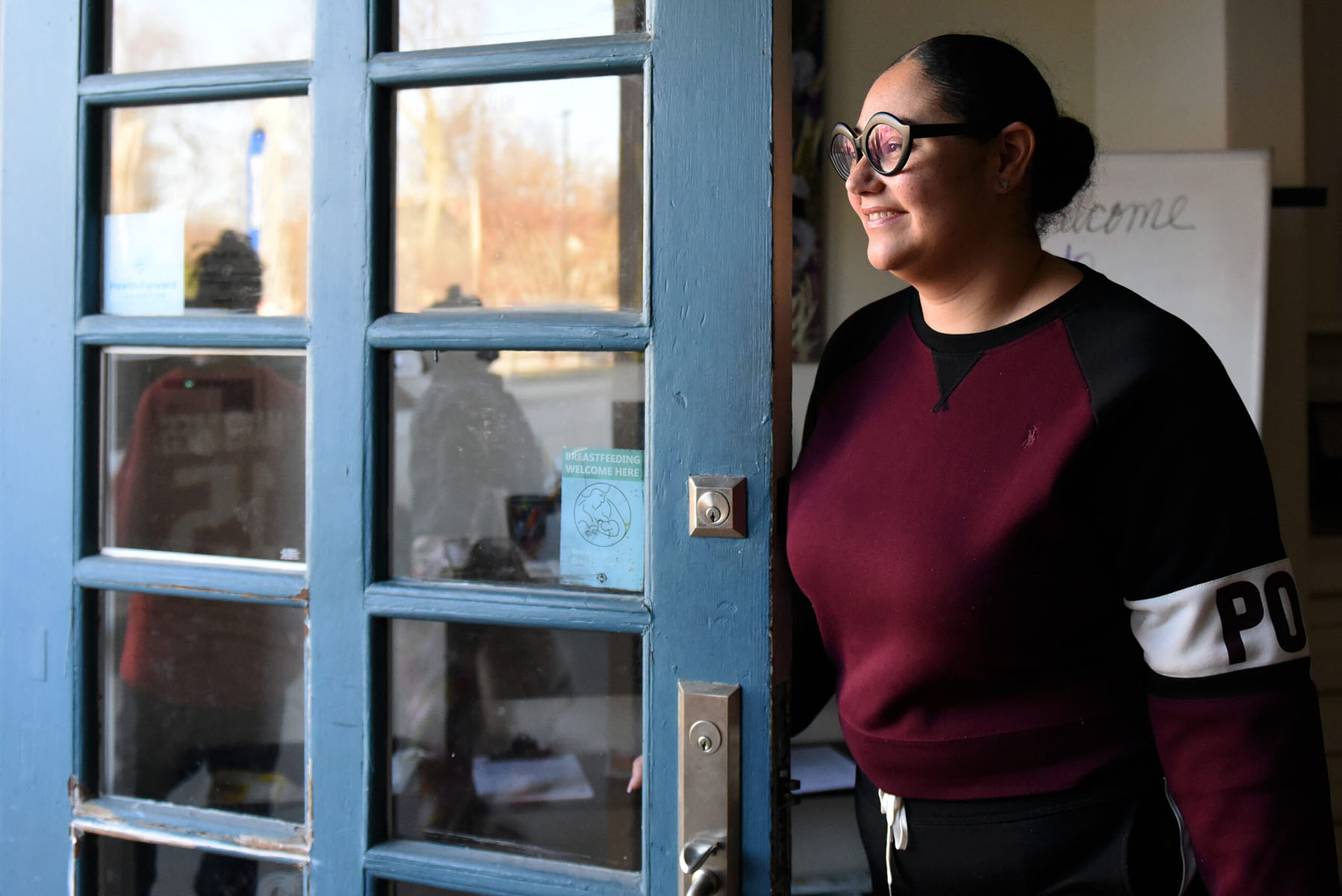 Christian King smiles as she opens the door to her birth center.