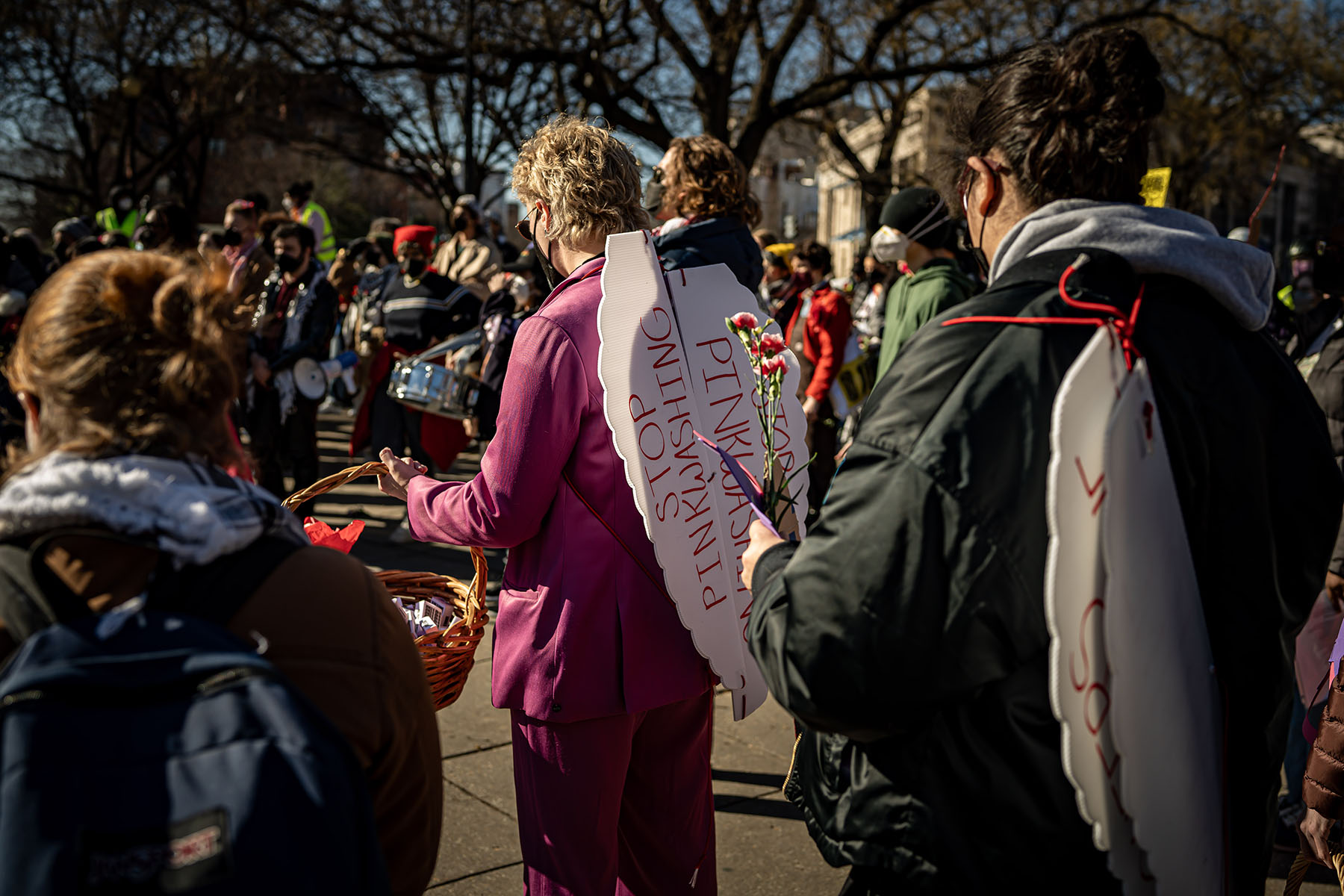 A protester wears angel wings that read "stop pinkwashing" during a protest in Washington, D.C.