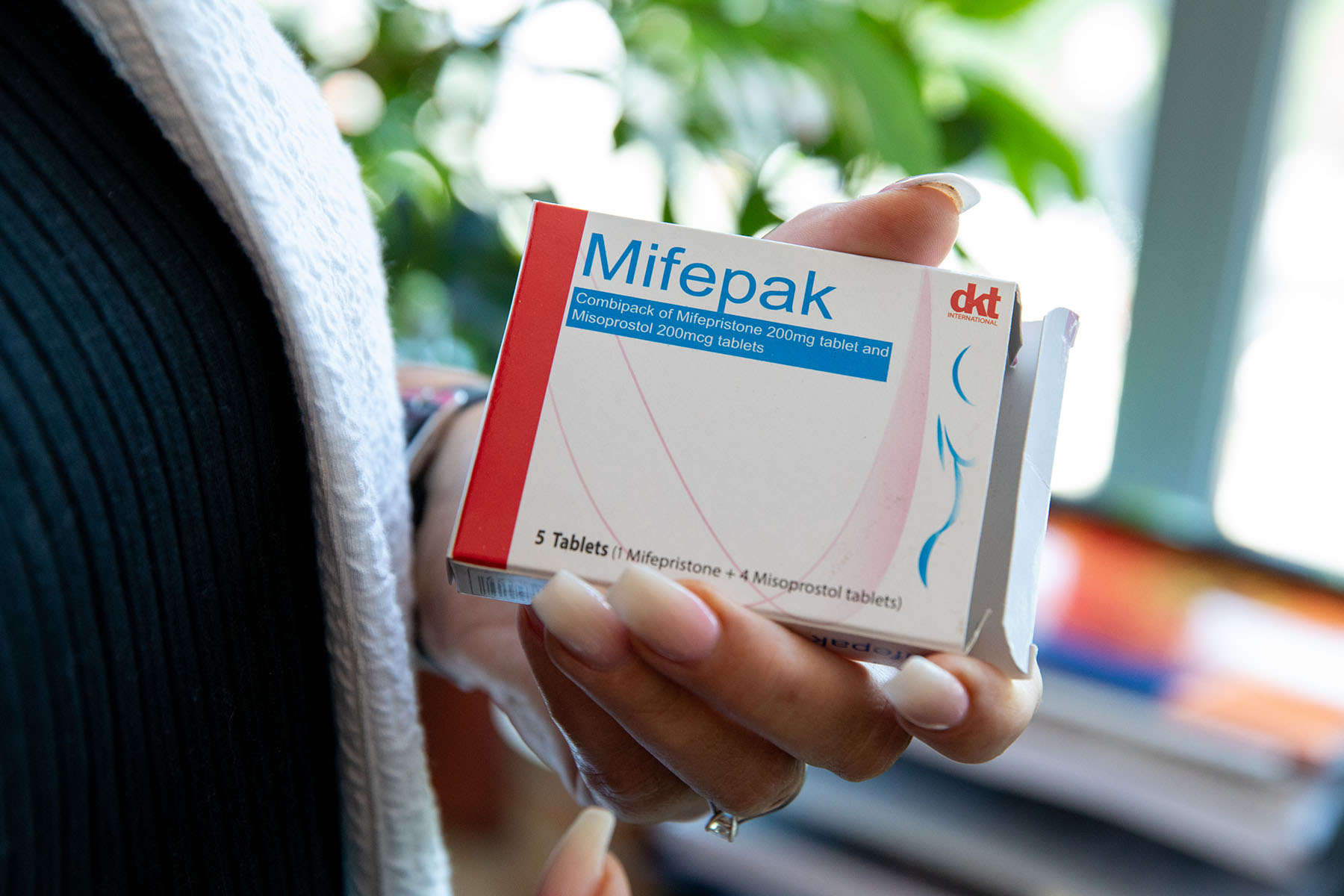 A woman holds a pack of pills used for abortions.