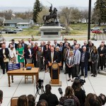 Gov. Greg Gianforte, surrounded by Republican lawmakers, speaks at a bill signing ceremony on the steps of the State Capitol.