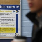 A poster for Real ID is seen on a cork board at a DMV.