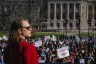 An attendee looks over a crowd of demonstrators at a rally to protest the passing of an anti-trans bill.