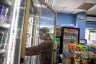 Morningstar grabs a drink inside a refregirator at a convenience store.