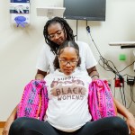Doulas with Birth in Color participate in a doula simulation training session.