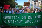 Protesters march while holding signs during an abortion-rights rally in Austin, Texas.