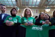 People listen as President Joe Biden delivers remarks on proposed spending on child care and other investments in the 