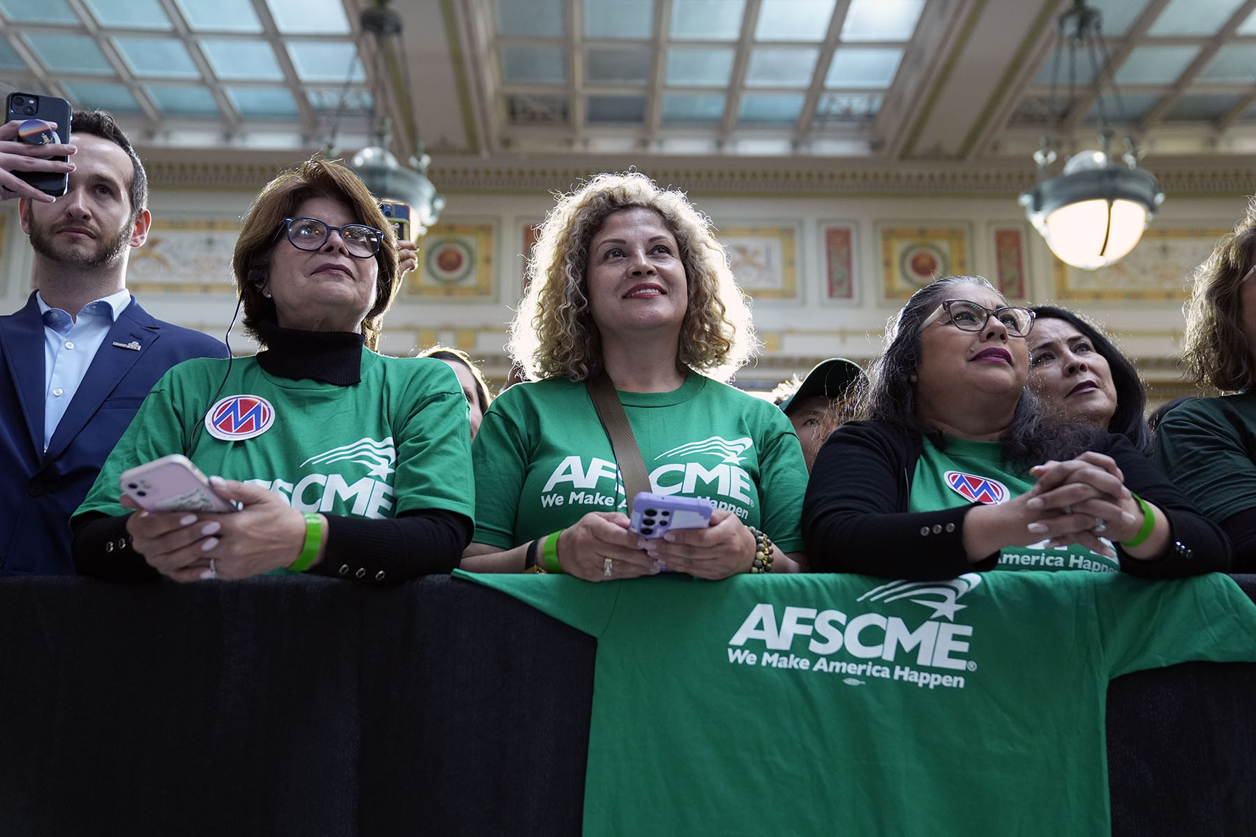 People listen as President Joe Biden delivers remarks on proposed spending on child care and other investments in the "care economy."