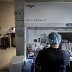 An embryologist works on freezing embryos inside a lab at a fertility center.