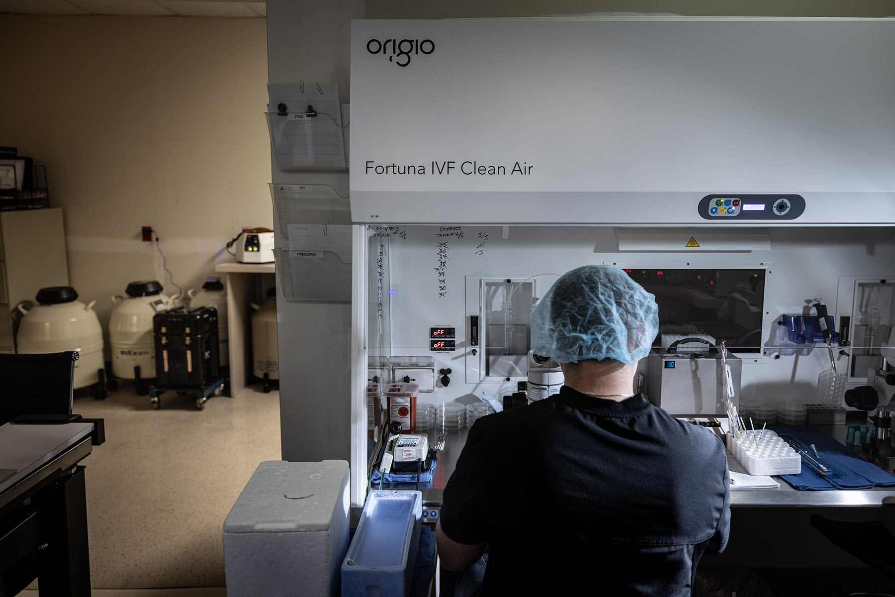 An embryologist works on freezing embryos inside a lab at a fertility center.