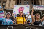 People protest in front of the Texas State Capitol during a Queer March demonstration.