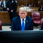 Former President Donald Trump arrives for his criminal trial with his legal team at Manhattan Criminal Court.