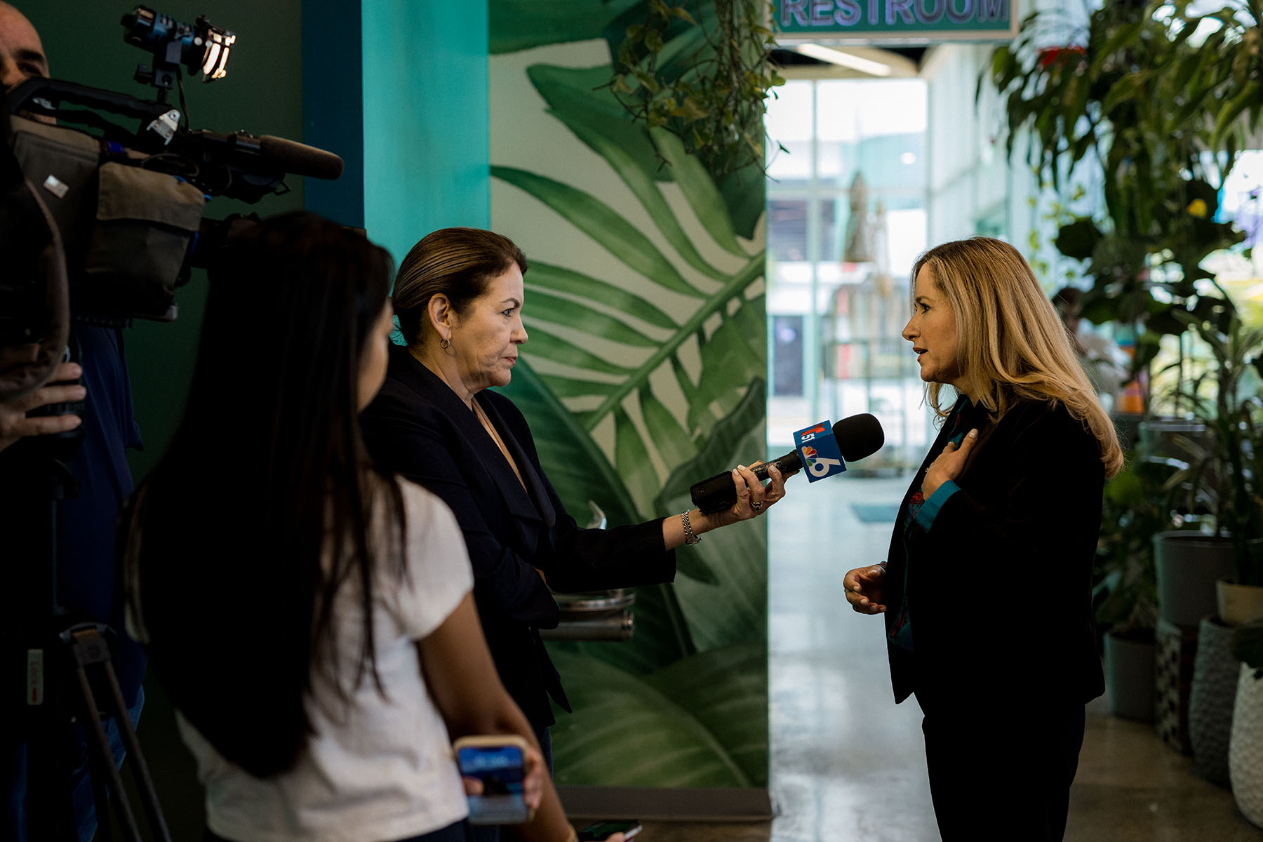 Debbie-Mucarsel-Powell is interviewed by a journalist holding a microphone as a camera crew films nearby.