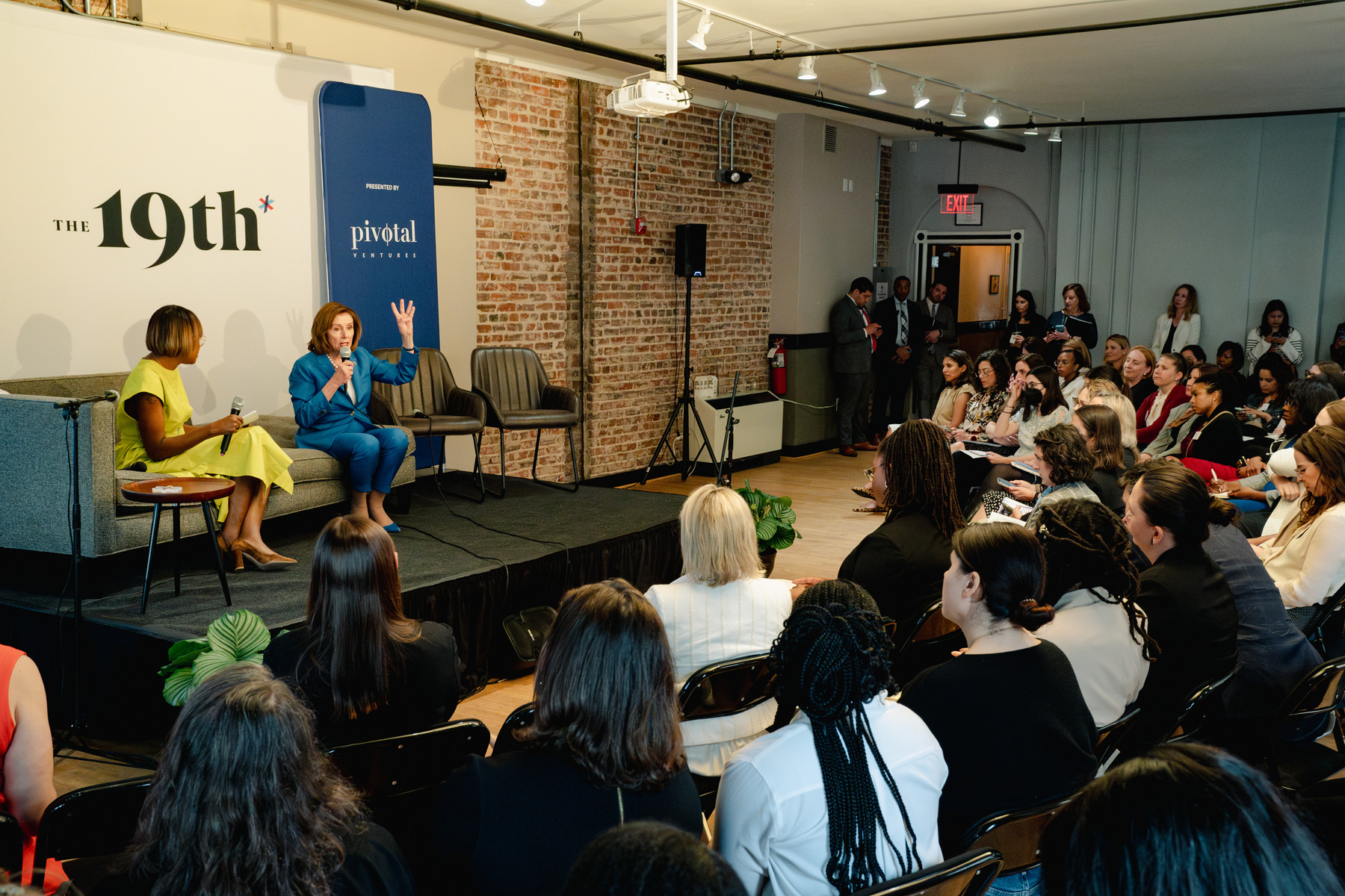 Errin Haines and Nancy Pelosi, the former speaker of the U.S. House, speak to a crowd.