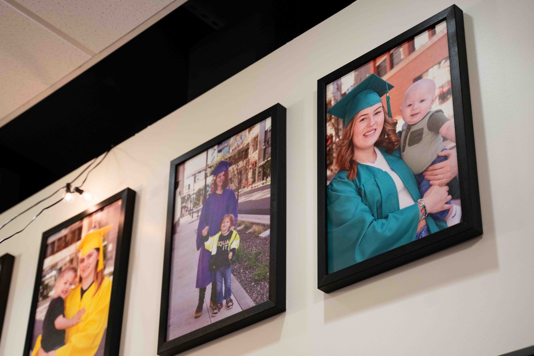 Photos of Lumen High graduates line the school’s hallway.