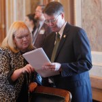 Kansas state Reps. Susan Concannon and Fred Patton confer during a session of the House.