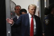 Former President Donald Trump waves to a crowd as he enters the court building in Manhattan.