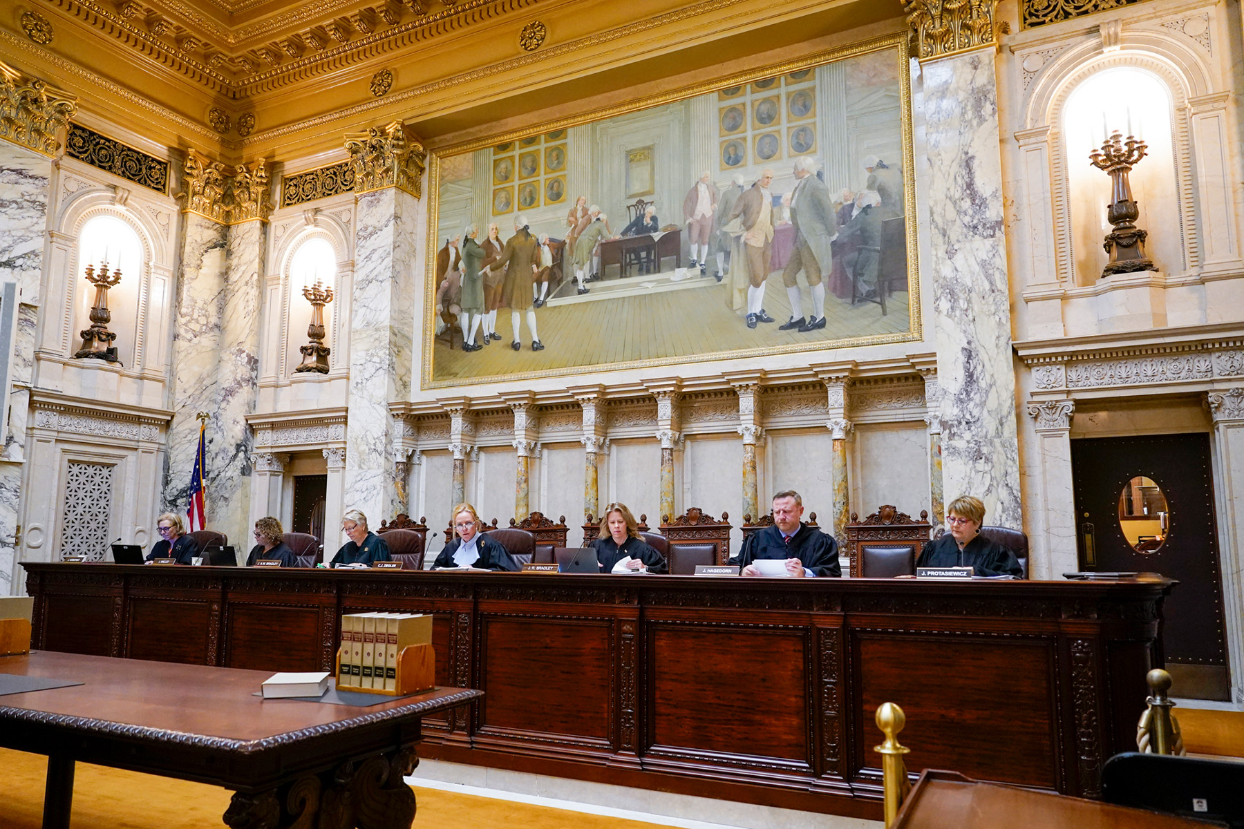 Justice consult documents inside the Wisconsin Supreme Court.