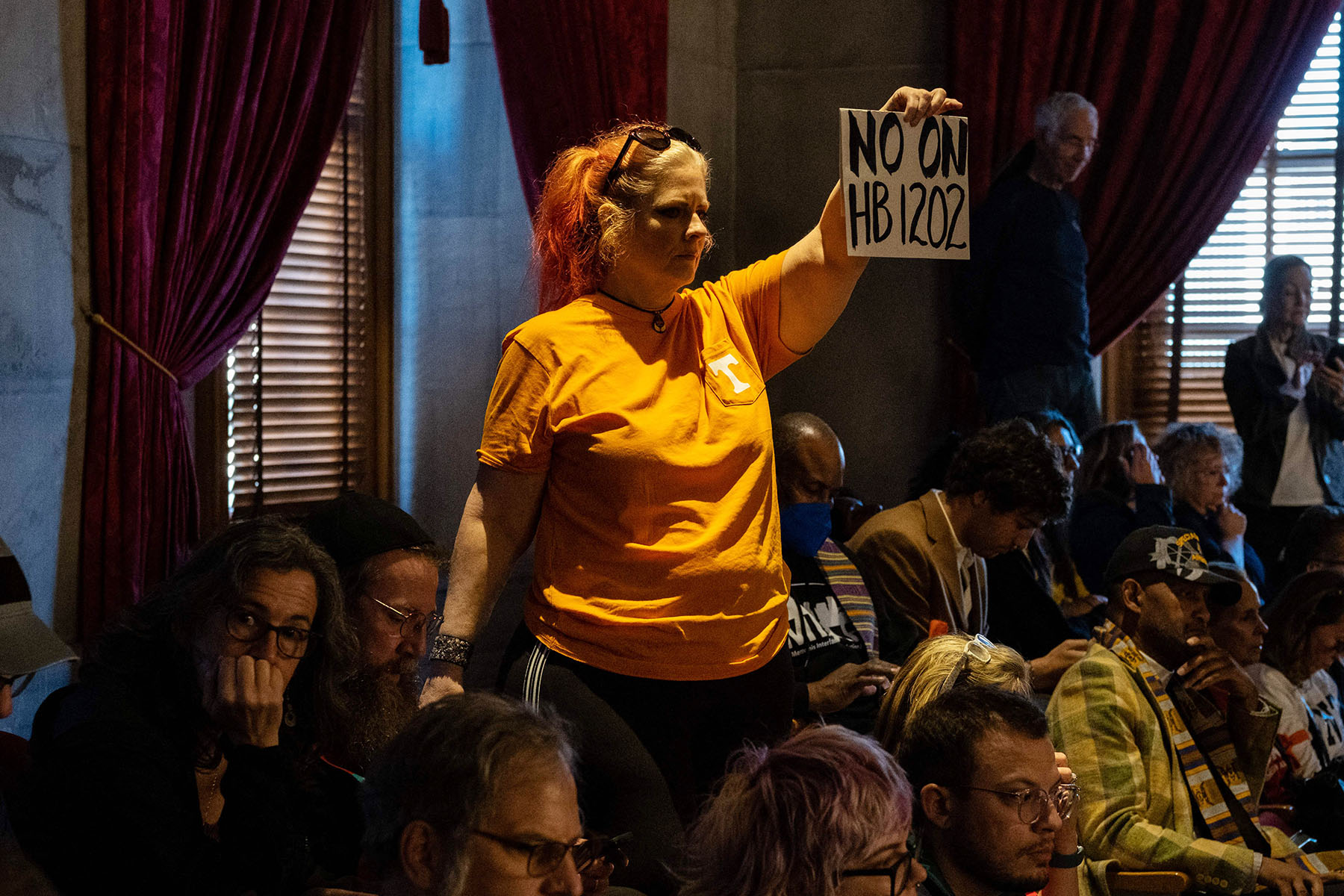 A demonstrator holds a sign reading "no on HB 1202," which would put guns in the hands of teachers, at the Tennessee State Capitol building in Nashville.