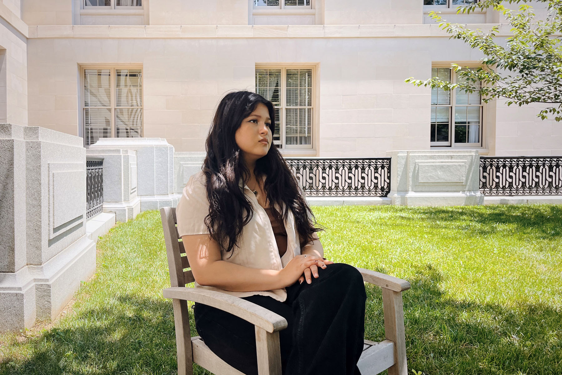 Yolenna Regmi poses for a portrait in a courtyard on Capitol Hill.