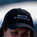 A volunteer wears a hat that reads 