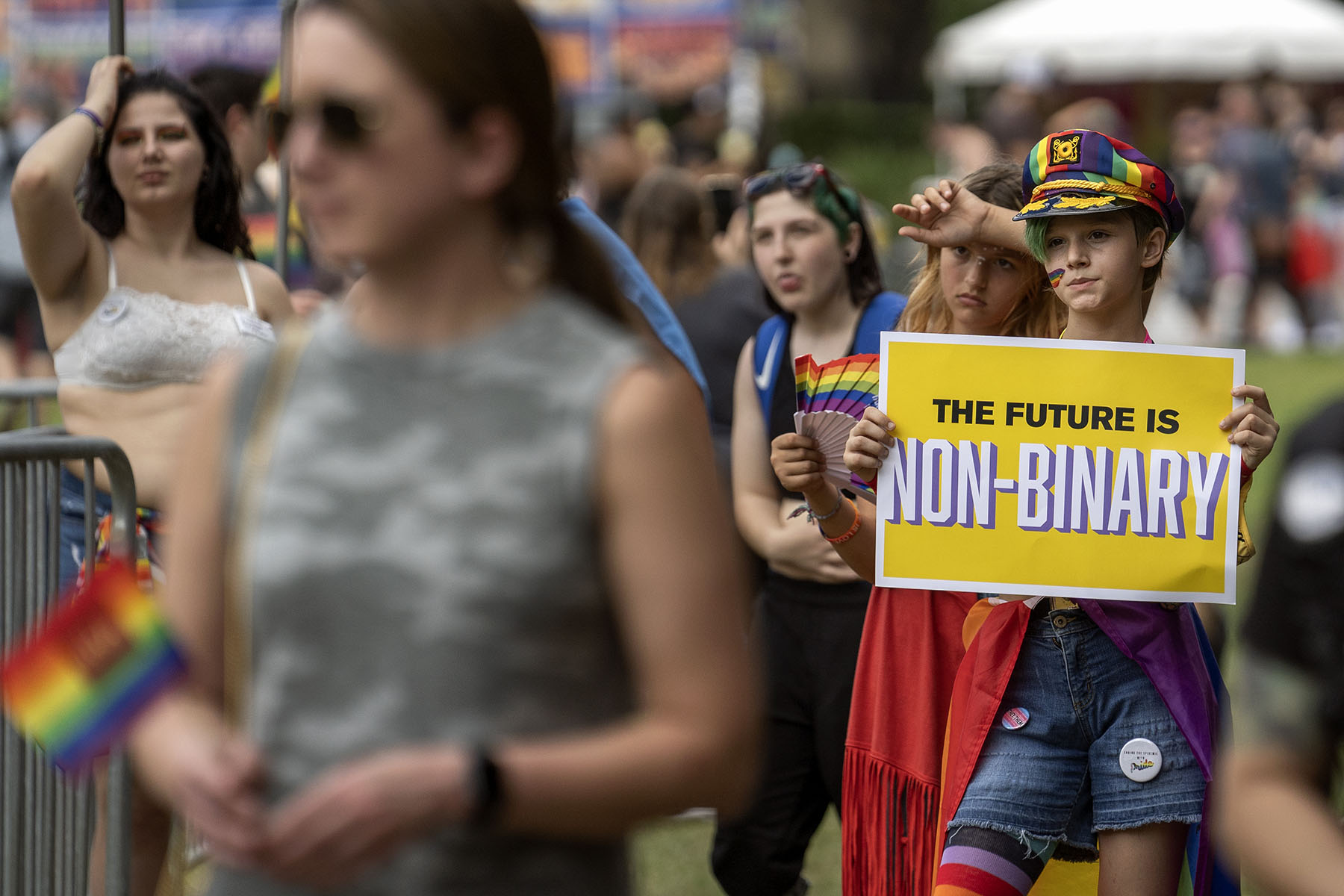 A young participant in the National Trans Visibility March holds a sign that reads "The Future is Non-Binary."