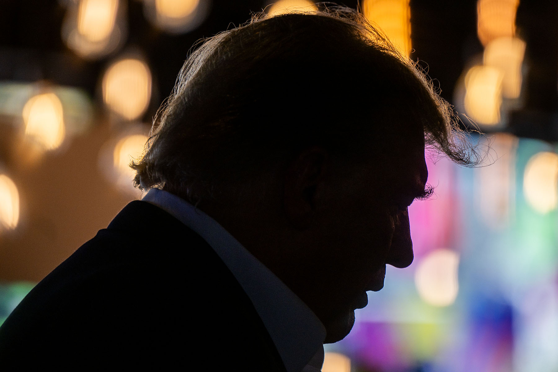 Trump's silhouette is seen as he arrives at a rally at the Iowa State Fair.