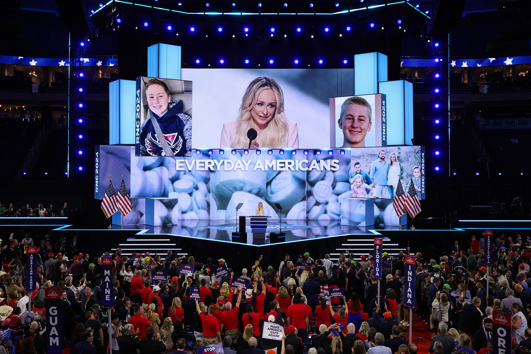 Anne Fundner speaks on stage as photos of her son are shown on screen.