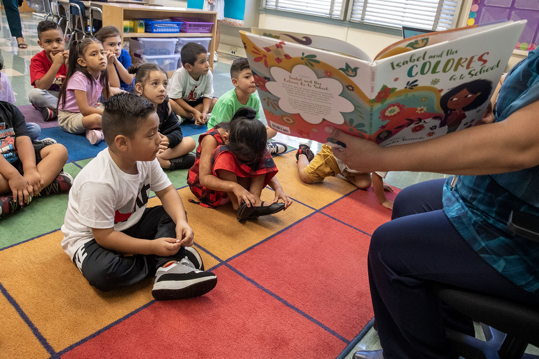 A teacher reads to a kindergarten class.