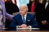 President Joe Biden signs a presidential memorandum in the Oval Office at the White House.